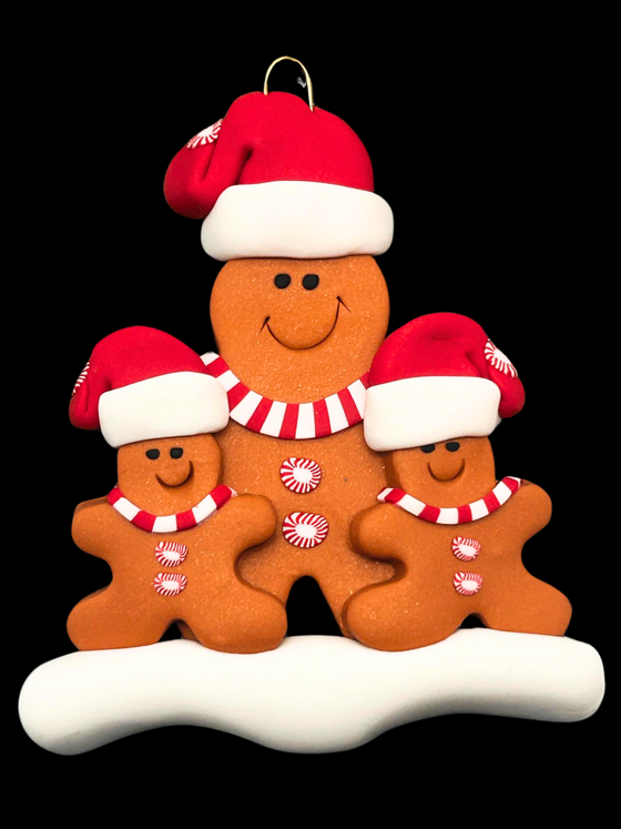 Big gingerbread man is in the middle and has 2 smaller gingerbread men on each side. All have red and white Santa hats, red and white mints as buttons, and red and white scarves.