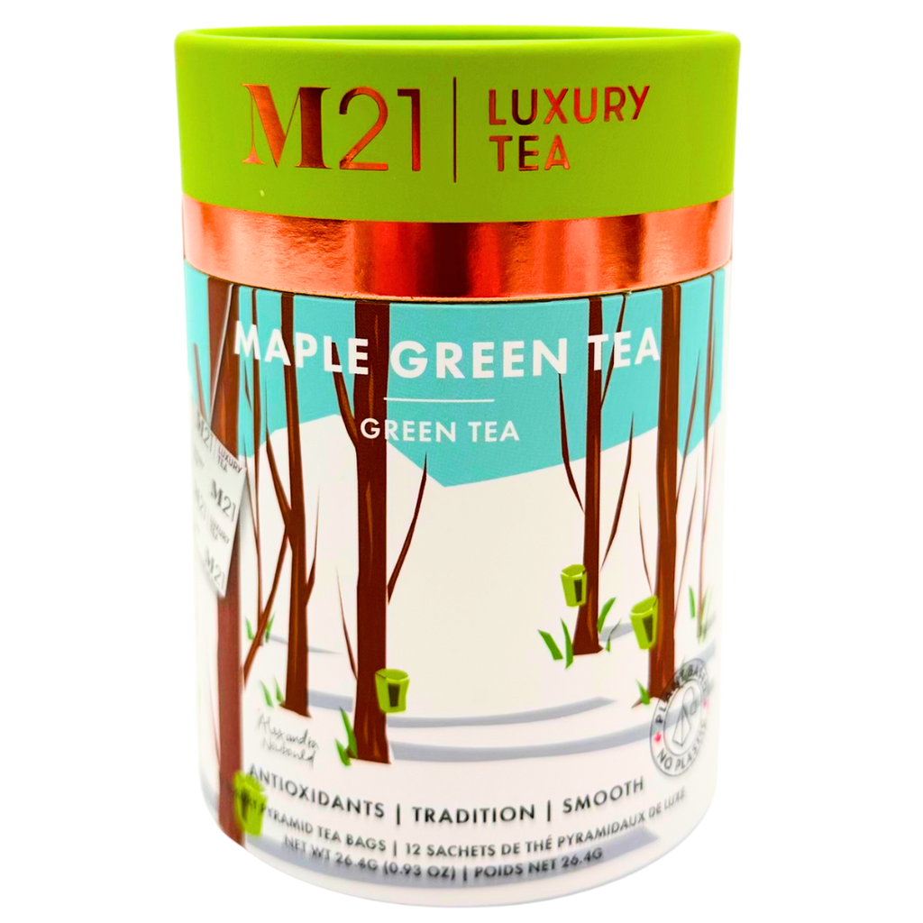 A cylindrical box that holds twelve maple green flavoured tea bags. The tea bags are pyramid shaped and are blended and packed in Canada. The container is made from 100% recycled paper. The illustration on the canister depicts a forest scene with maple trees. Small green buckets hang from the trees representing the maple syrup harvest. The green in the imagery matches the green coloured lid. It includes instructions to brew for three to five minutes. 