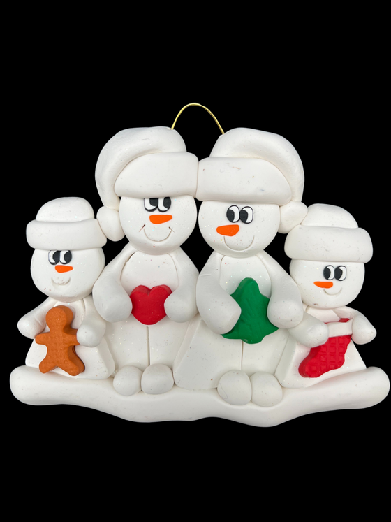 Four snowmen in white hats smile at each other. The larger ones hold a heart and a Christmas tree. The smaller ones on either side hold a gingerbread man and a Chtistmas stocking.