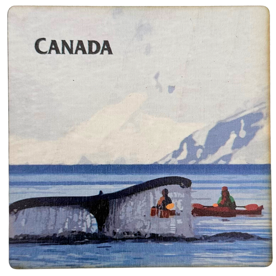 A square wooden coaster with a whale fluke about to slap the water. Two people in kayaks observe in the midground, with a mountain in the background. The coaster says "Canada" in the top left corner.