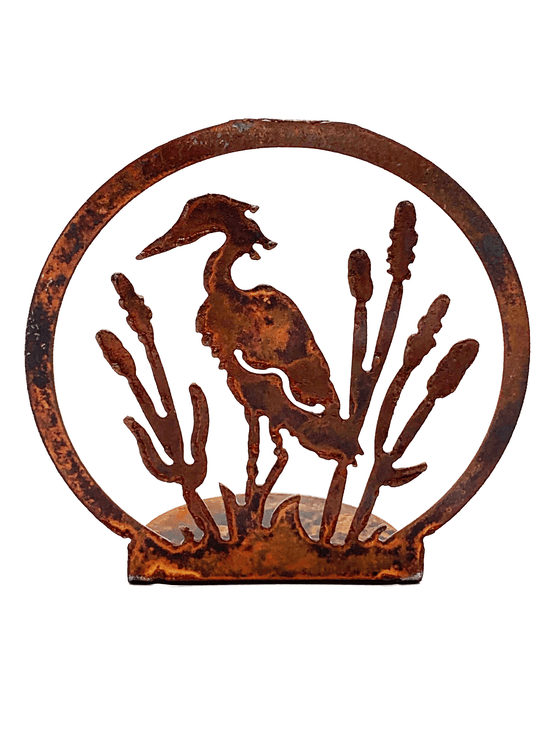 A heron stands tall in a reedy marsh. The scene is cut from sheet steel and then oxidised to a tasteful red patina.