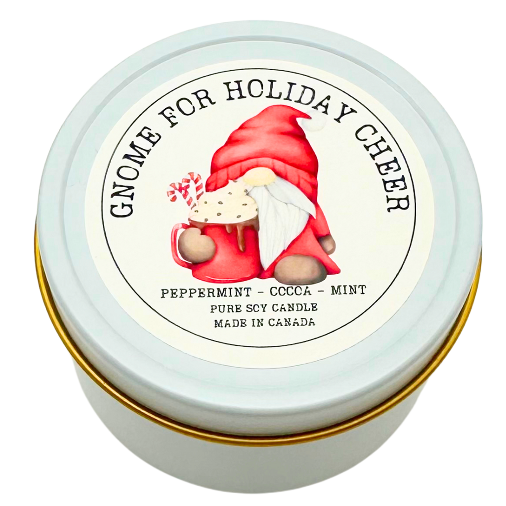 A small candle in a white tin. The top has a picture of santa claus drinking a hot chocolate.