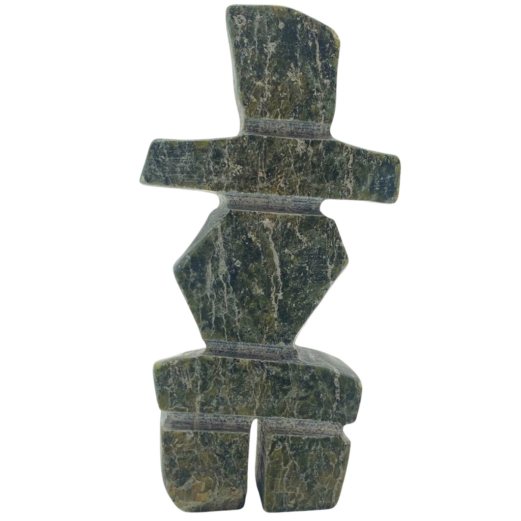 A human-shaped inukshuk sculpture, approximately 3 inches high. The stone is mottled black and green soapstone.