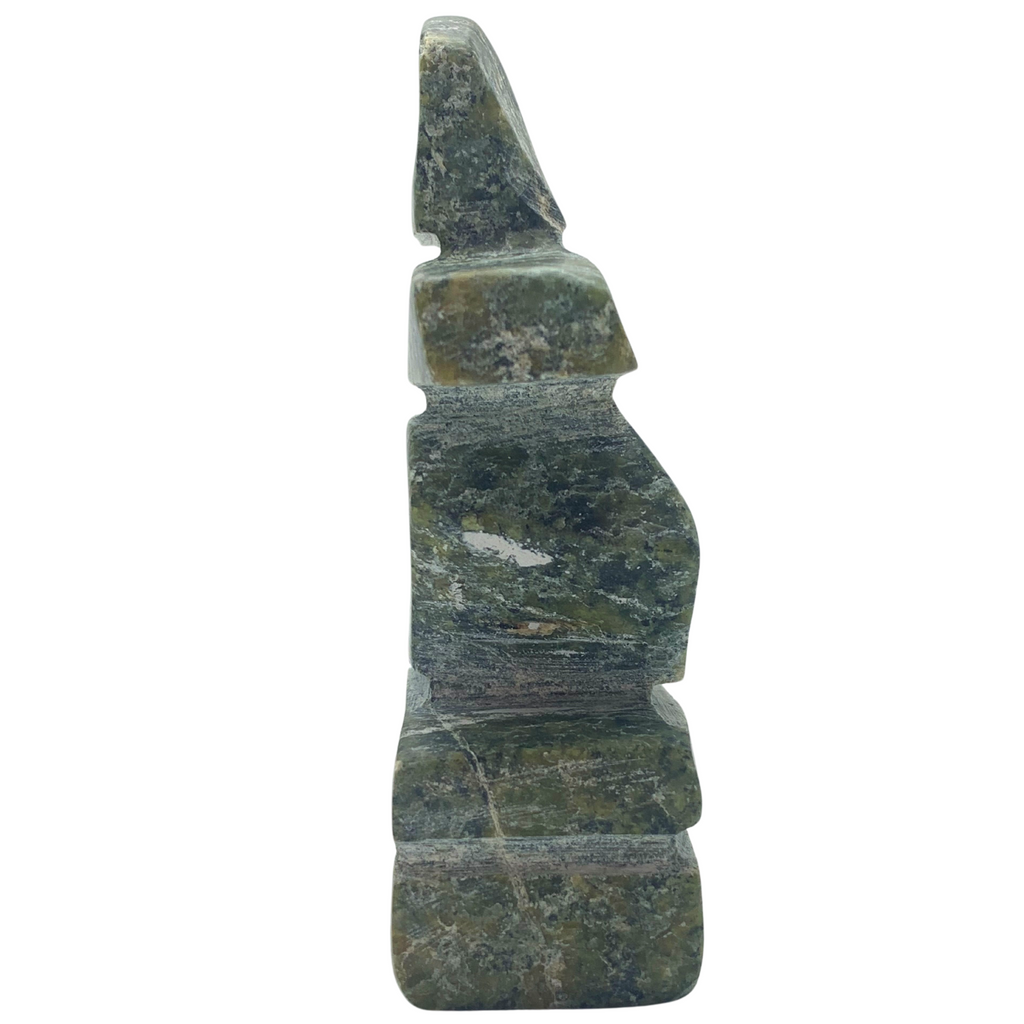 A human-shaped inukshuk sculpture, approximately 3 inches high. The stone is mottled black and green soapstone.