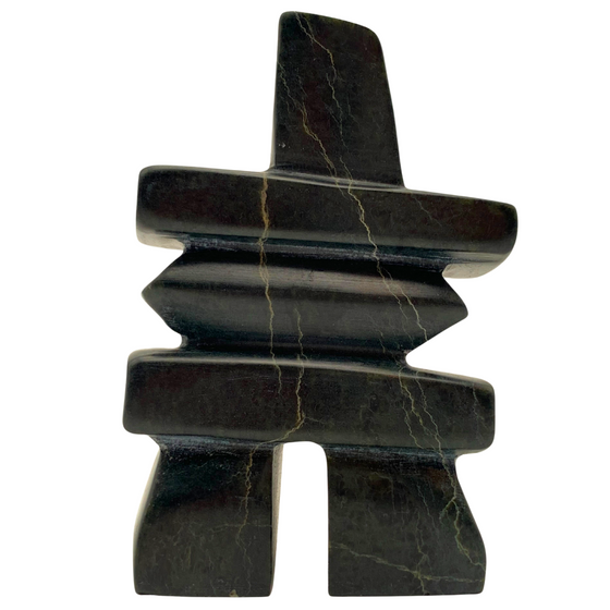 A human-shaped inukshuk sculpture, approximately 4 inches high. The stone is mottled black and green soapstone.