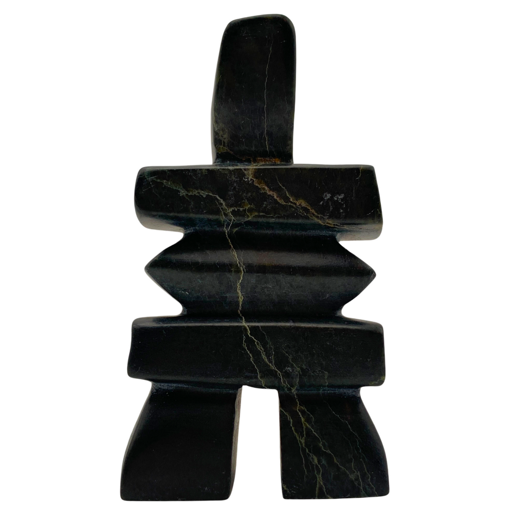 A human-shaped inukshuk sculpture, approximately 5 inches high. The stone is mottled black and green soapstone.