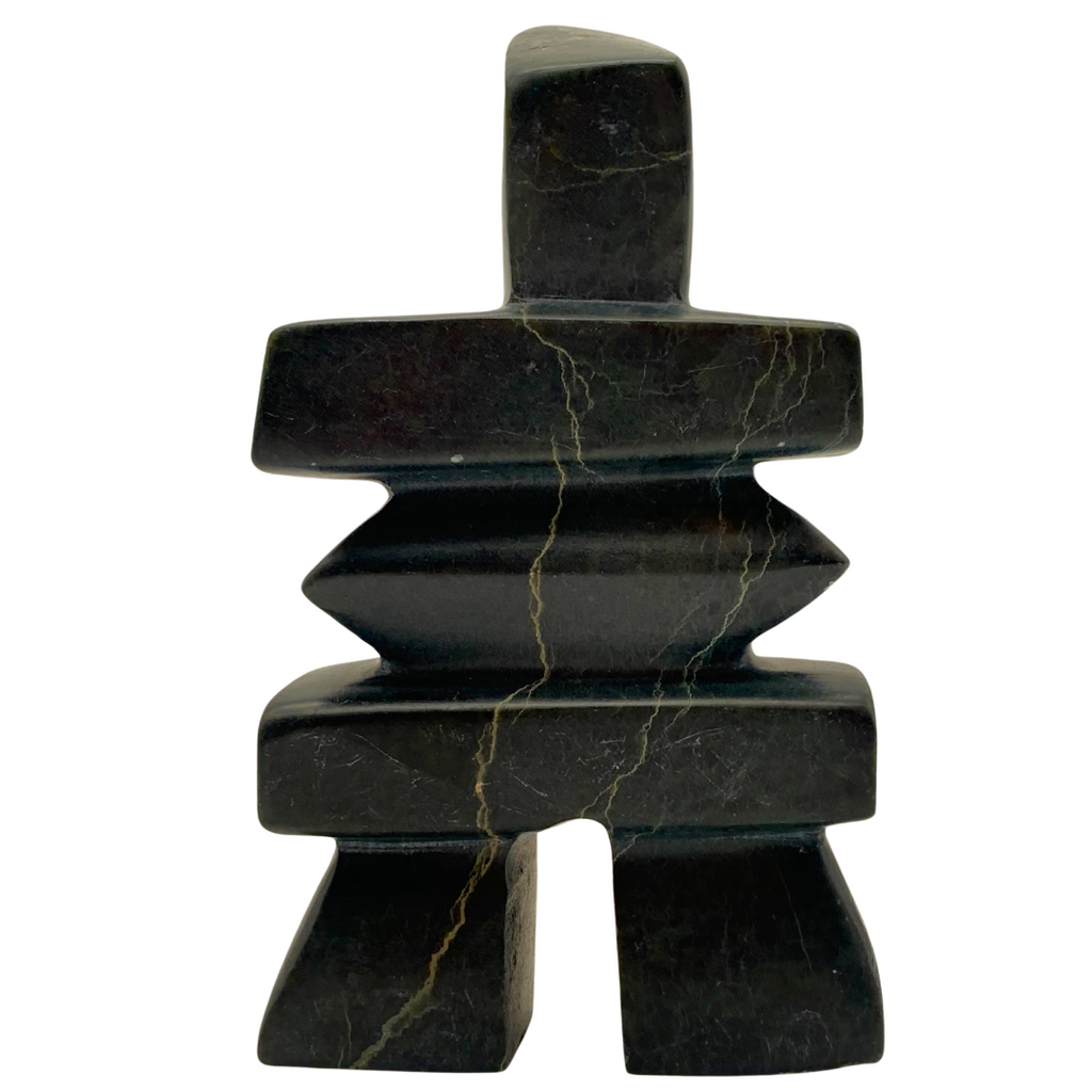 A human-shaped inukshuk sculpture, approximately 5 inches high. The stone is mottled black and green soapstone.