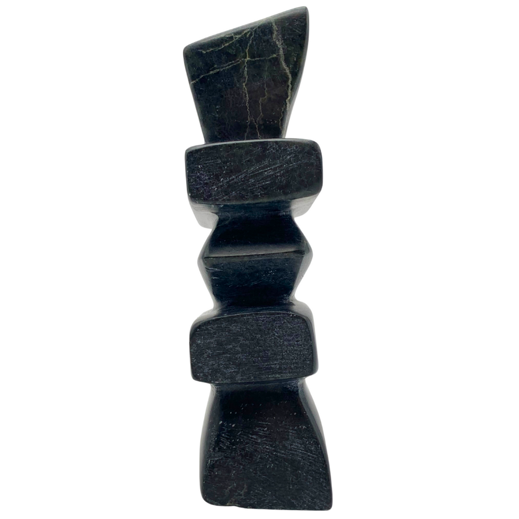 A human-shaped inukshuk sculpture, approximately 5 inches high. The stone is mottled black and green soapstone.