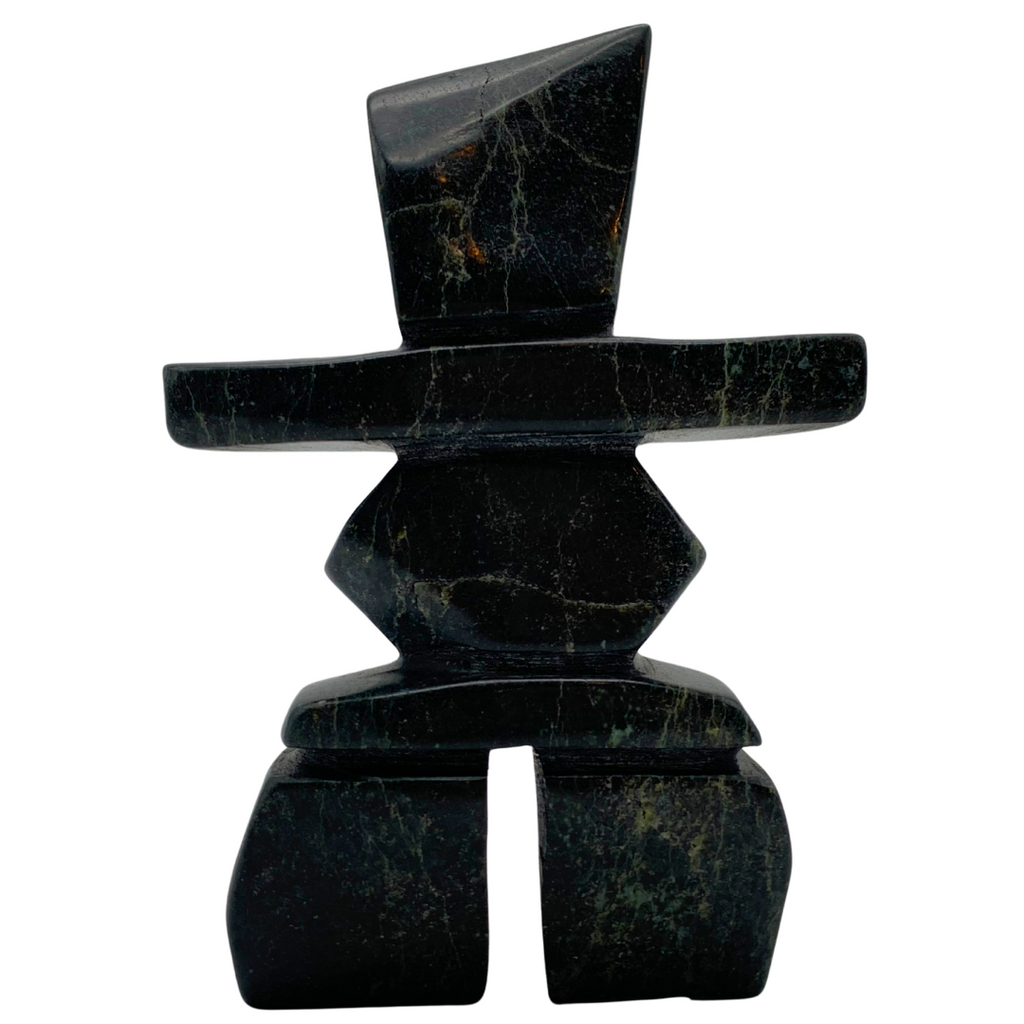 A human-shaped inukshuk sculpture, approximately 5 inches high. The stone is mottled black and green soapstone.