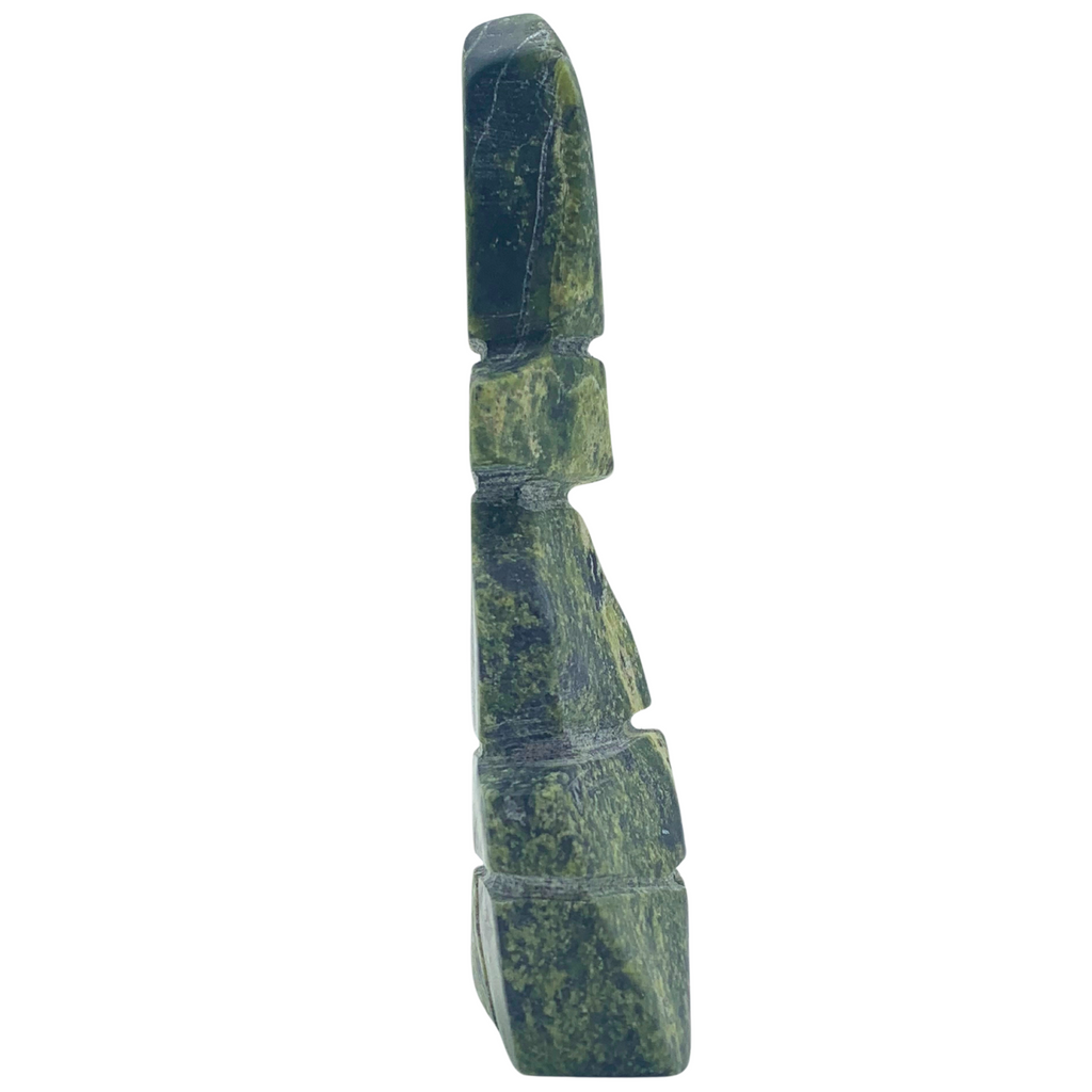 A human-shaped inukshuk sculpture, approximately 4.5 inches high. The stone is mottled black and green soapstone.