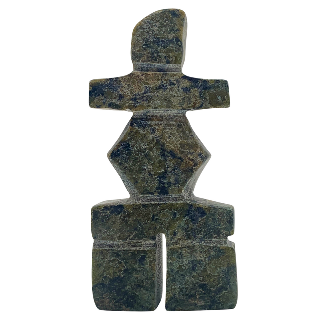 A human-shaped stone sculpture. The stone is mottled green and black serpentine.