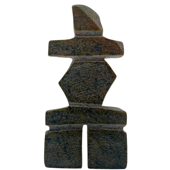 A human-shaped stone sculpture. The stone is mottled green and black serpentine.