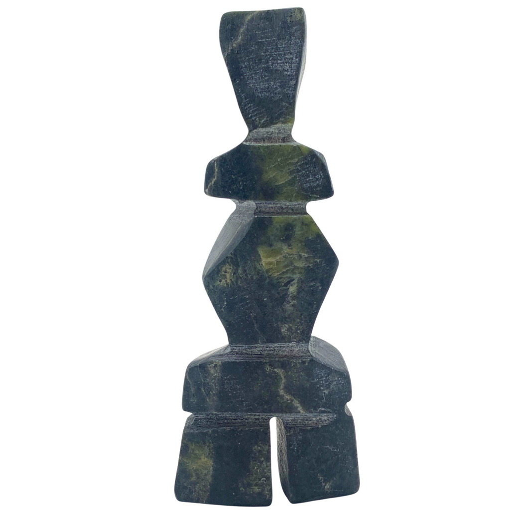 A human-shaped inukshuk sculpture, approximately 4 inches high. The stone is mottled black and green soapstone.