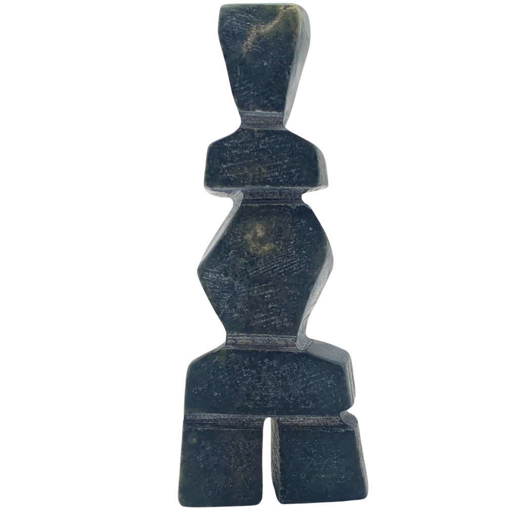 A human-shaped inukshuk sculpture, approximately 4 inches high. The stone is mottled black and green soapstone.