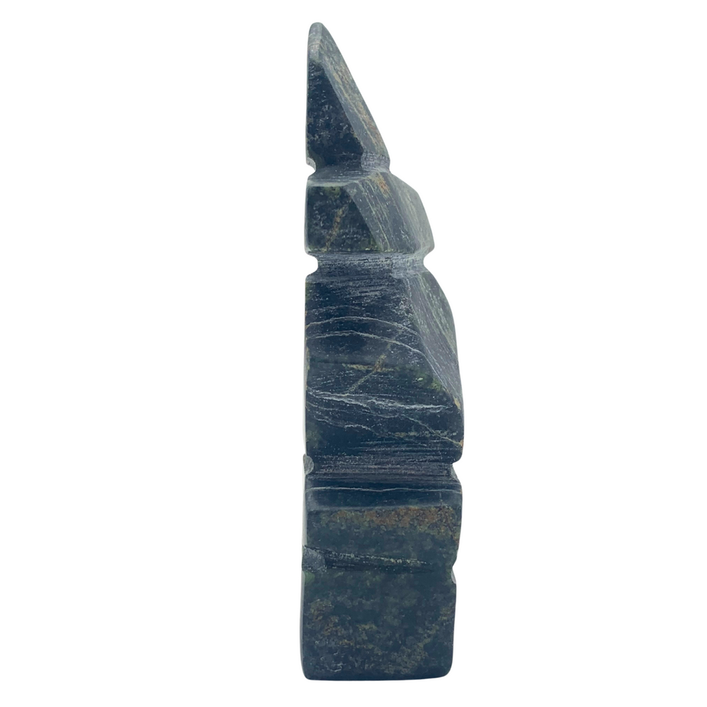 A human-shaped inukshuk sculpture, approximately 3.5 inches high. The stone is mottled black, brown and green soapstone.