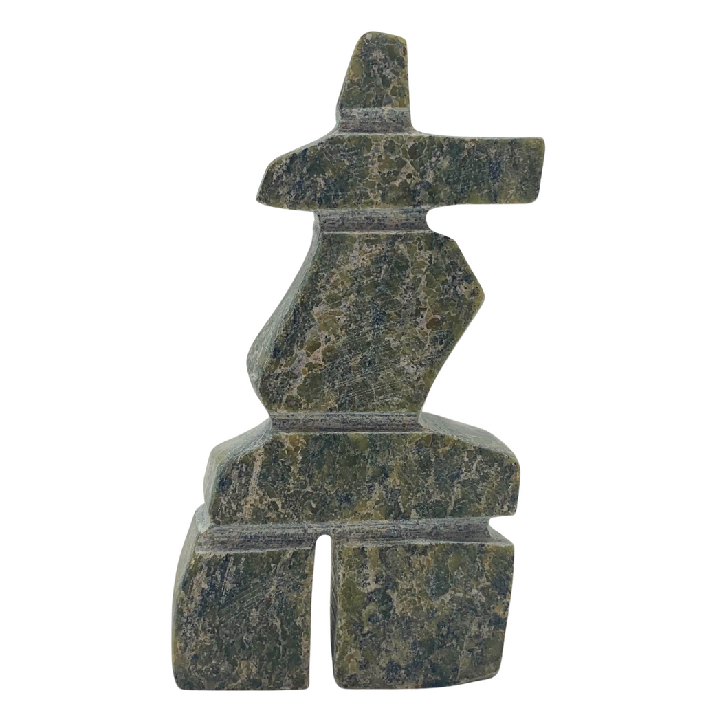 A human-shaped inukshuk sculpture, approximately 3 inches high. The stone is mottled black and green soapstone.