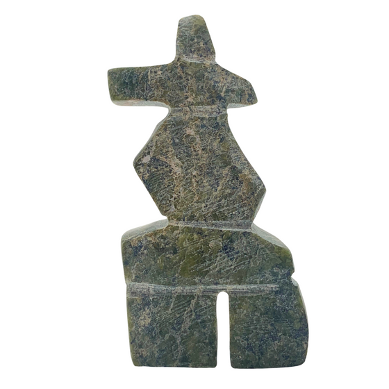 A human-shaped inukshuk sculpture, approximately 3 inches high. The stone is mottled black and green soapstone.