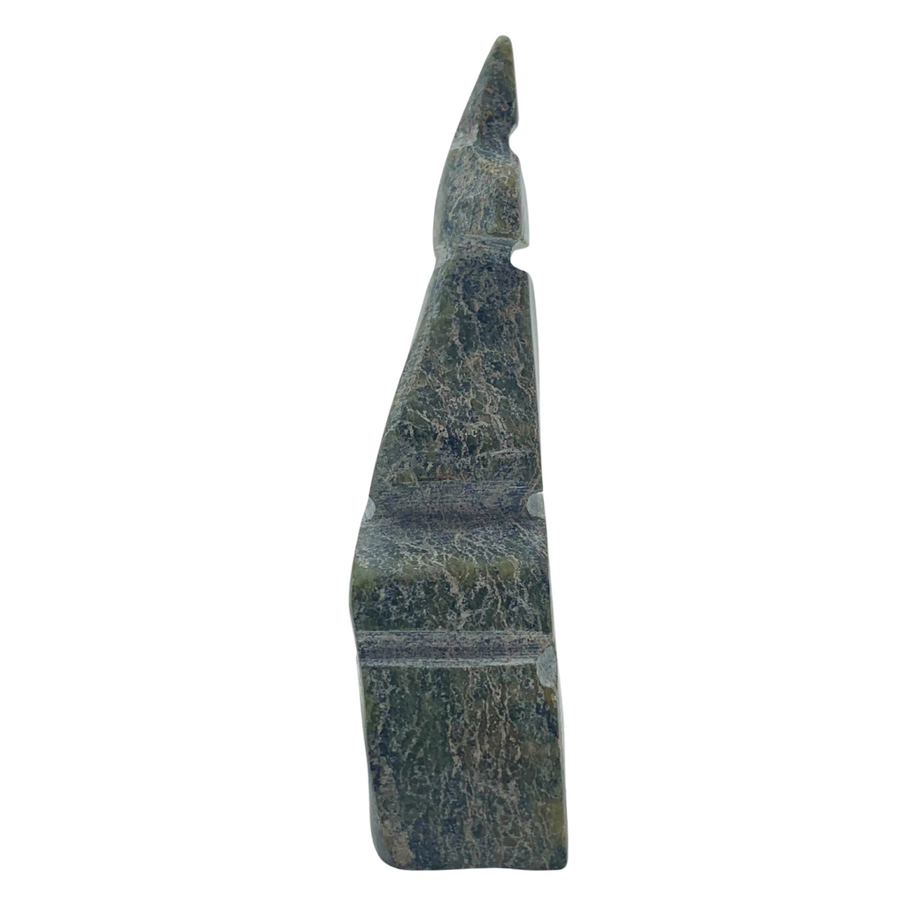 A human-shaped inukshuk sculpture, approximately 3 inches high. The stone is mottled black and green soapstone.