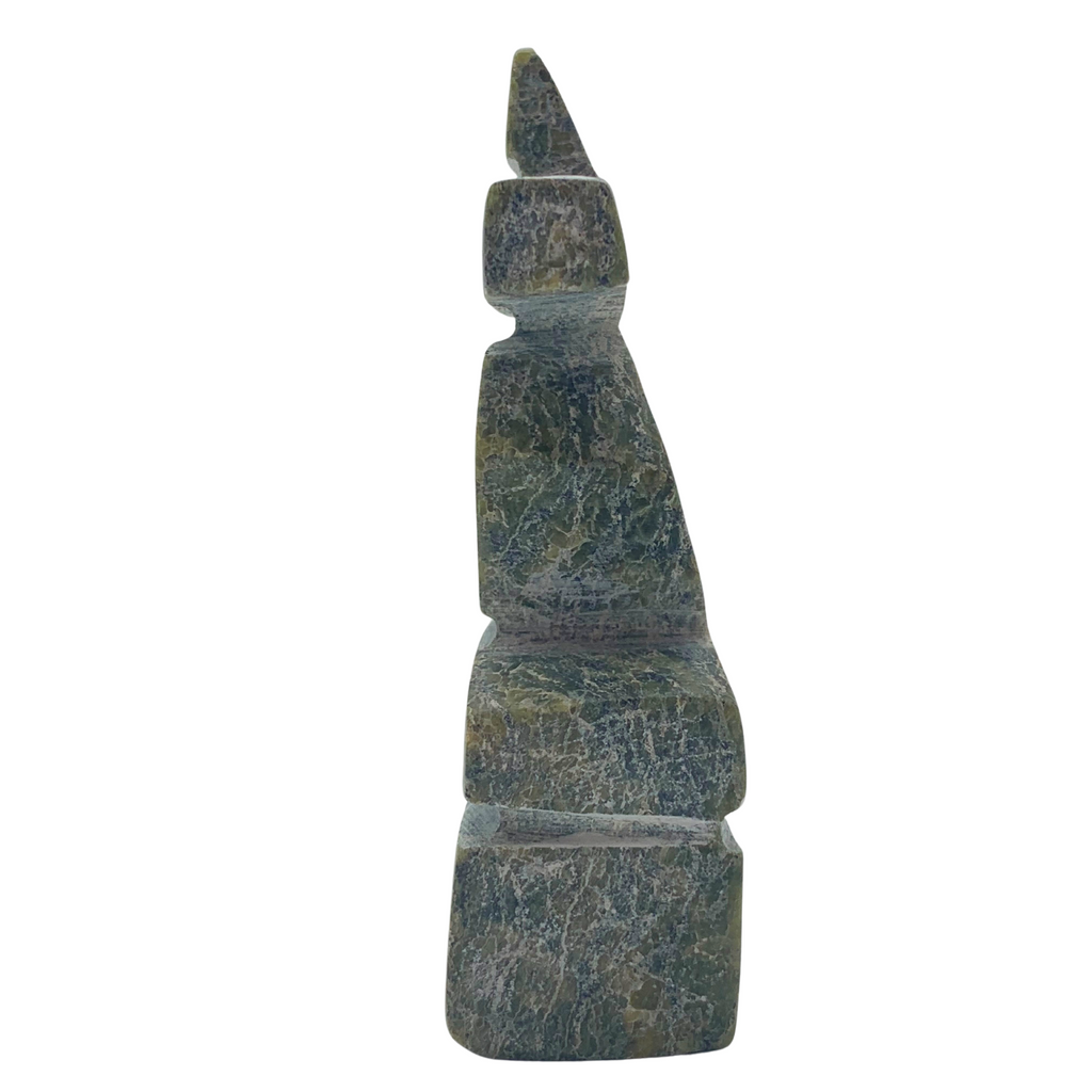 A human-shaped inukshuk sculpture, approximately 3 inches high. The stone is mottled black and green soapstone.