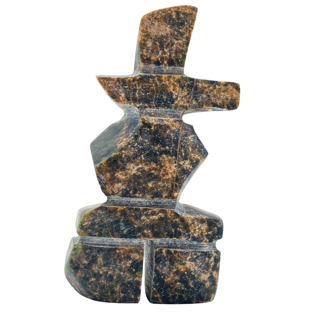 A human-shaped inukshuk sculpture, approximately 3 inches high. The stone is mottled black and brown soapstone.