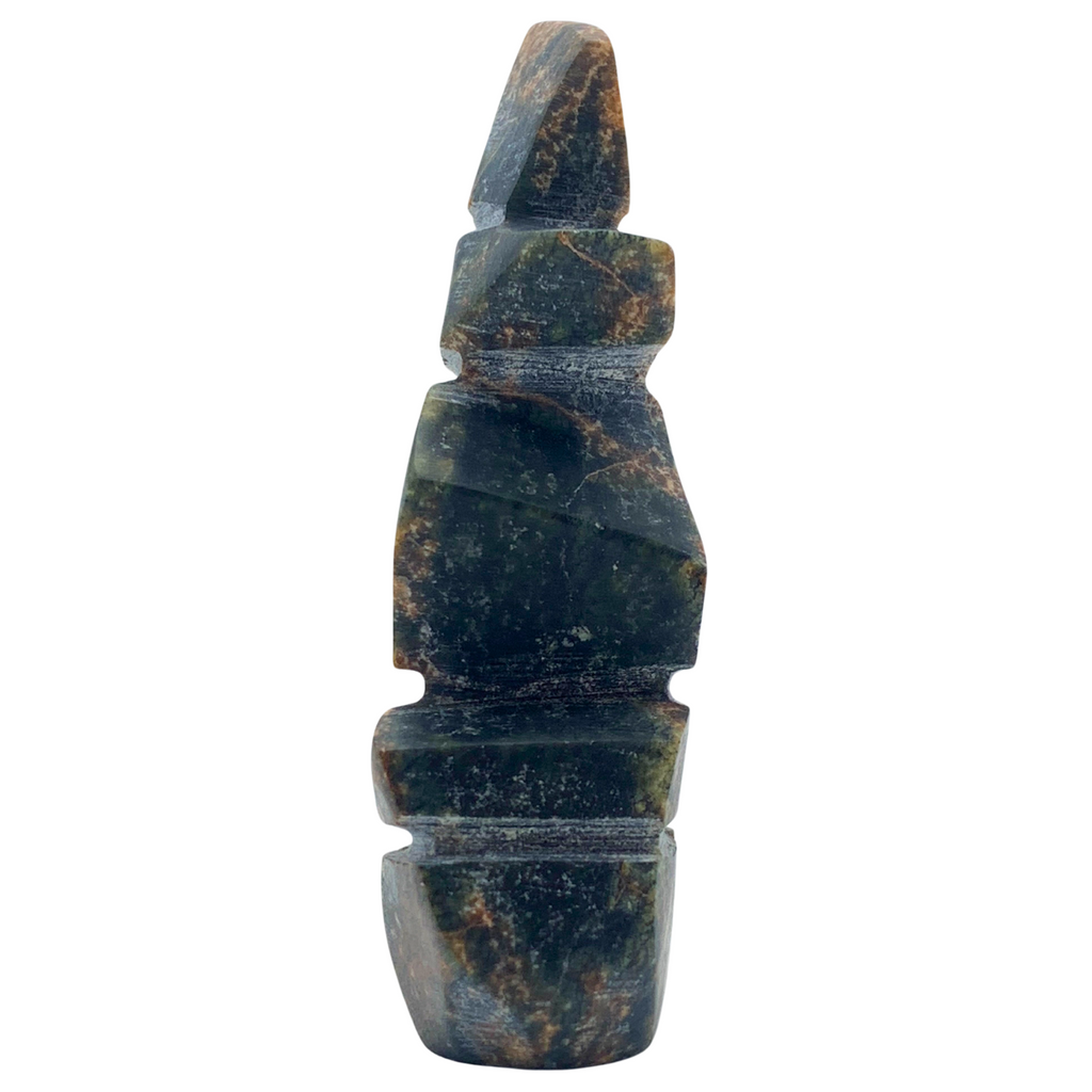 A human-shaped inukshuk sculpture, approximately 3 inches high. The stone is mottled black and brown soapstone.