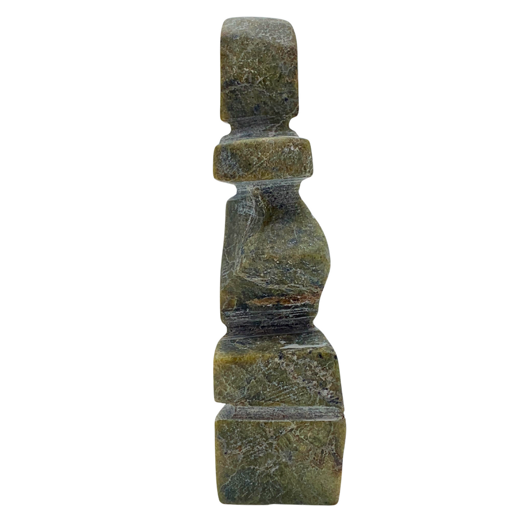 A human-shaped inukshuk sculpture, approximately 4 inches high. The stone is mottled black and green soapstone.