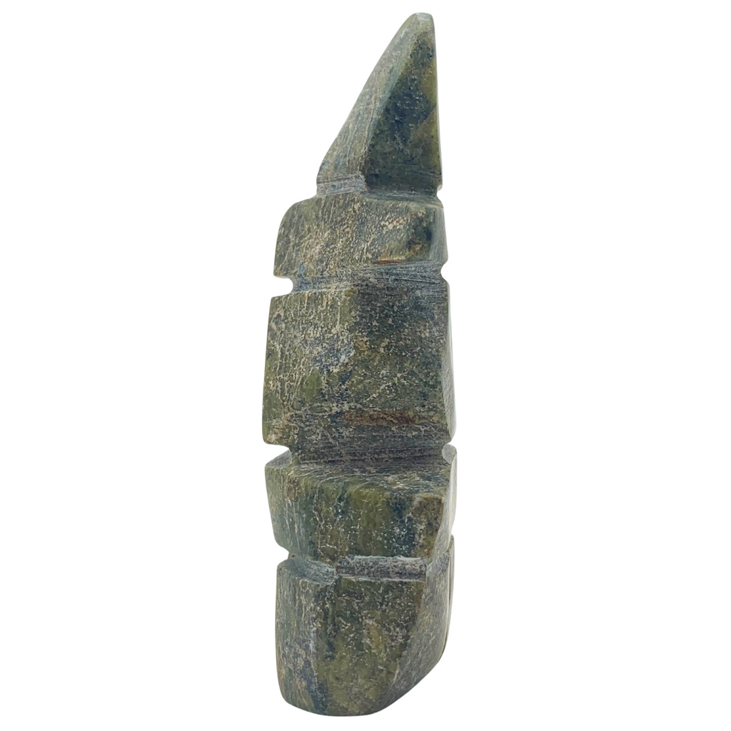 A human-shaped inukshuk sculpture, approximately 3 inches high. The stone is mottled black and green soapstone.