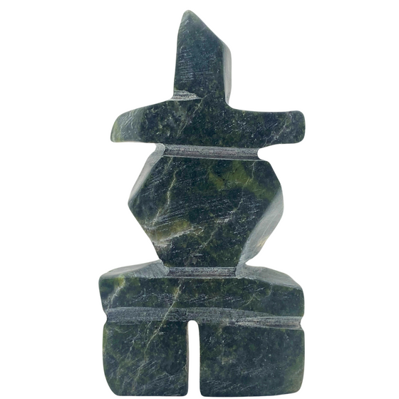 A human-shaped inukshuk sculpture, approximately 4 inches high. The stone is mottled black and green soapstone.