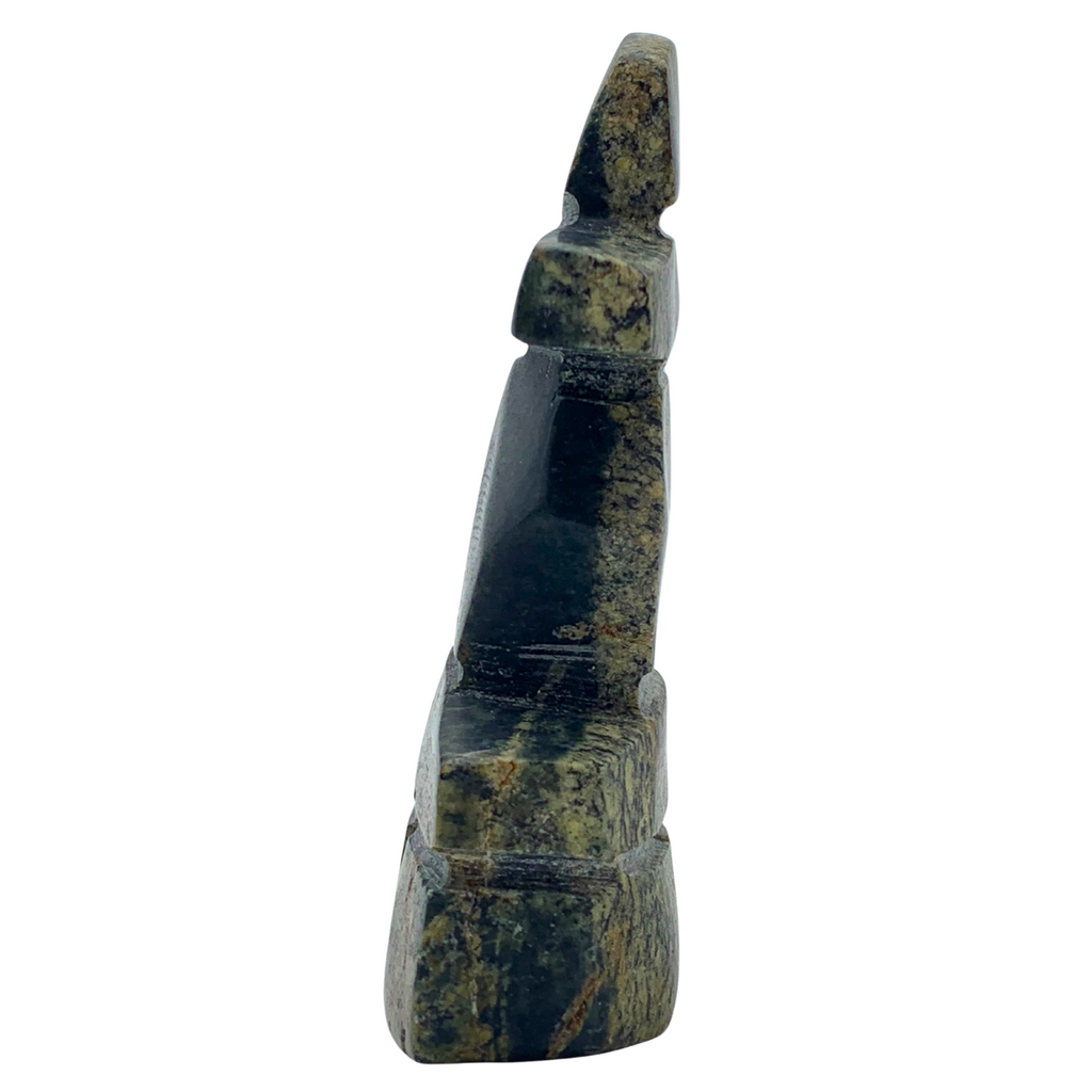 A human-shaped stone sculpture, approximately 3 inches high. The stone is black and brown.