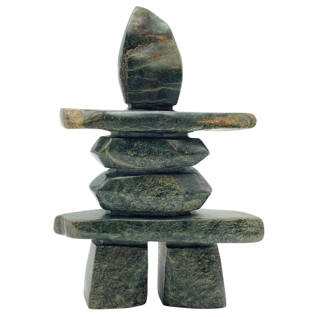 A human-shaped inukshuk sculpture, approximately 5 inches high. The stone is mottled black and green soapstone.