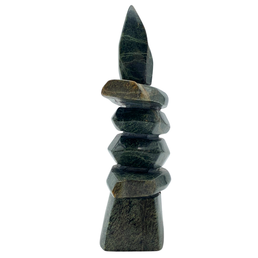 A human-shaped inukshuk sculpture, approximately 5 inches high. The stone is mottled black and green soapstone.