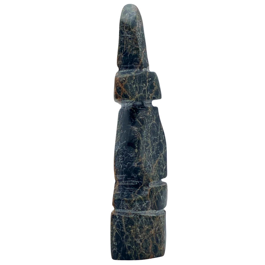 A human-shaped inukshuk sculpture, approximately 4 inches high. The stone is mottled black, brown and green soapstone.