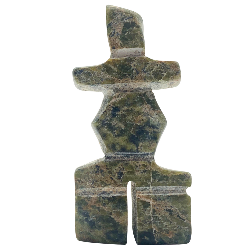 A human-shaped inukshuk sculpture, approximately 3 inches high. The stone is mottled black and green soapstone.