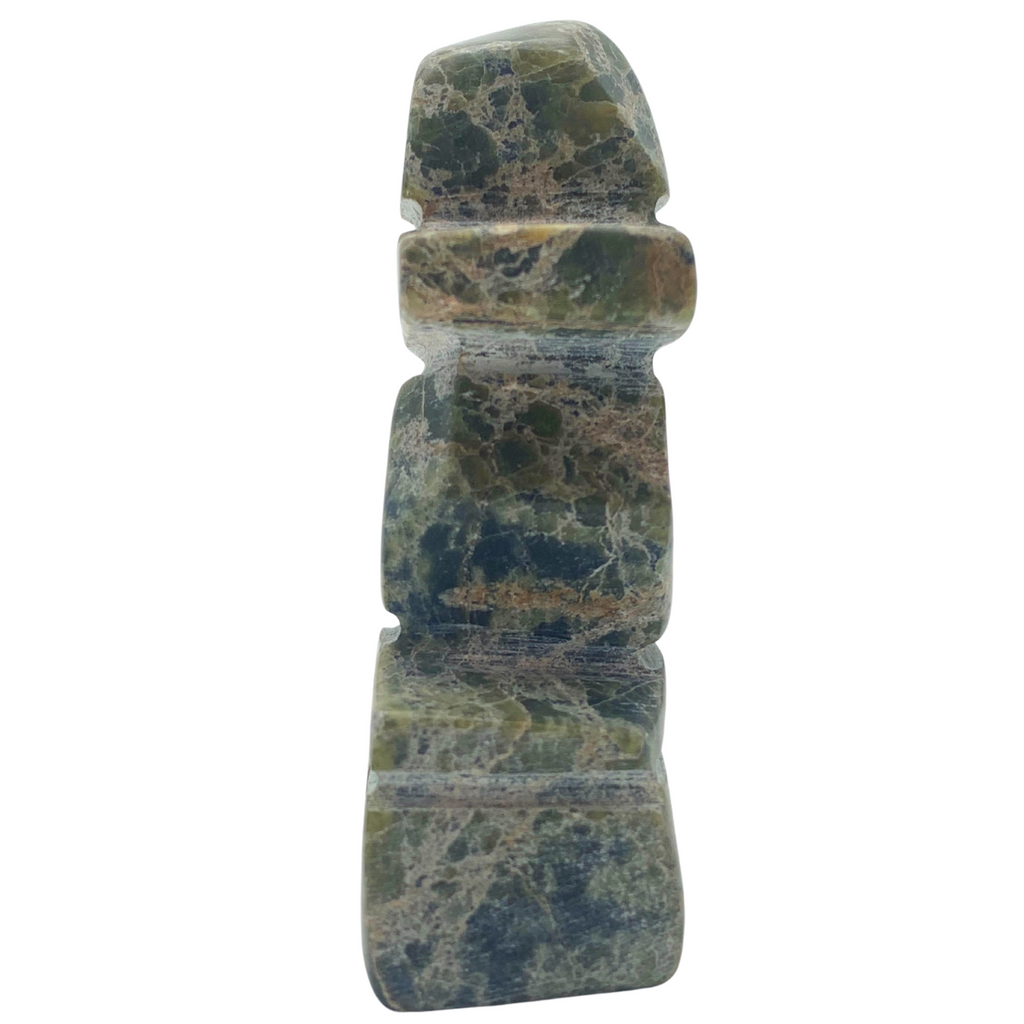 A human-shaped inukshuk sculpture, approximately 3 inches high. The stone is mottled black and green soapstone.