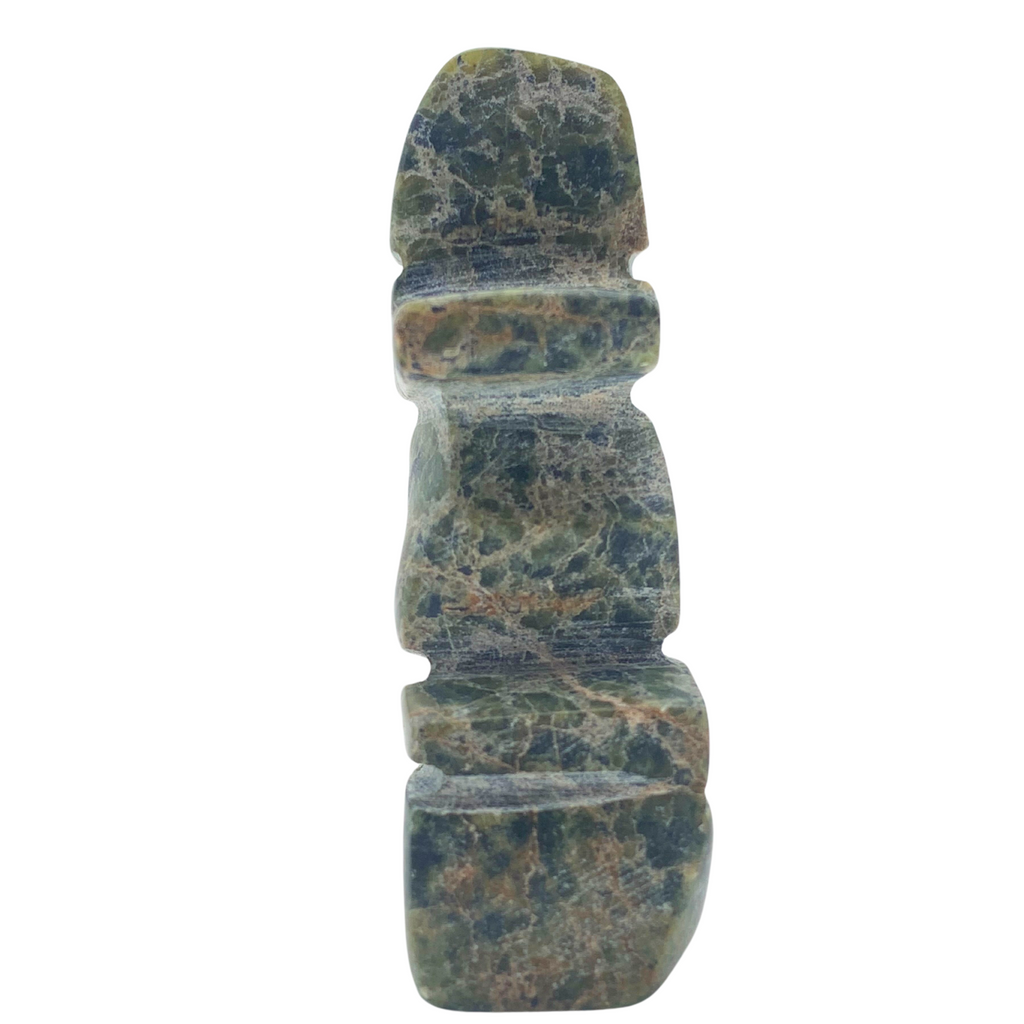 A human-shaped inukshuk sculpture, approximately 3 inches high. The stone is mottled black and green soapstone.