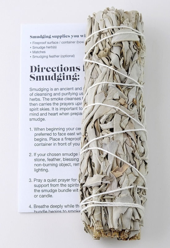 A traditional dried sage bundle used for smudging. A card with step-by-step directions for a successful smudging ceremony.