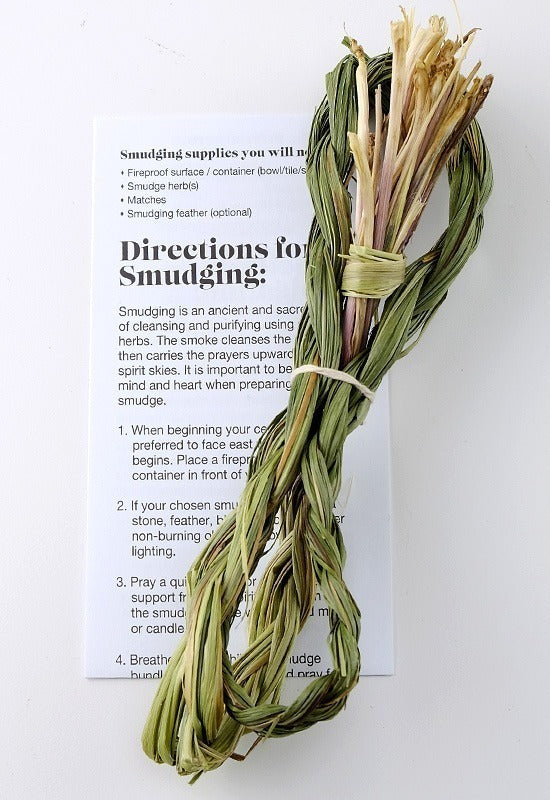 A traditional dried sweetgrass braid used for smudging. A card with step-by-step directions for a successful smudging ceremony.