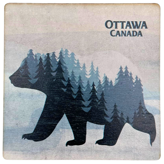 A square magnet featuring the silhouette of a bear walking in a white snowy landscape. The bear's body features a landscape of dark and light blue trees with a white sky. "Ottawa, Canada" is written in dark blue at the top right.