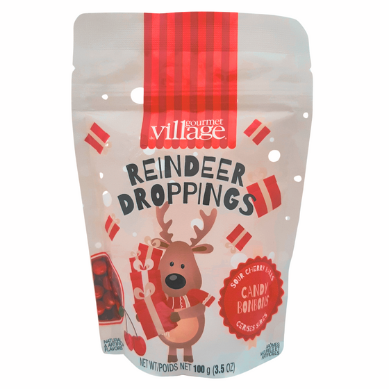 A reindeer carries a teetering stack of presents. A bowl of delicious sour cherry candies sits beside the reindeer.